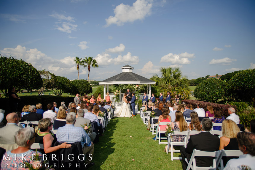 bride and groom at an outdoor wedding under a beautiful blue sky